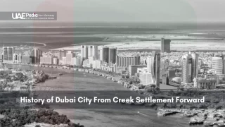 Aerial view of Dubai Creek with early skyscrapers and sea in background
