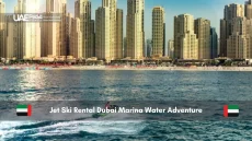 Person jet skiing in front of Dubai Marina skyscrapers
