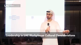 Emirati leader speaking at a workplace conference on cultural considerations.