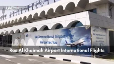 Exterior of Ras Al Khaimah International Airport showcasing a welcome banner for travelers.