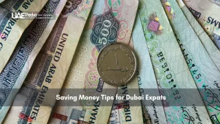 UAE dirham notes and one-dirham coin laid out in a fan shape