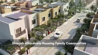 Row of modern villas in Sharjah with solar panels and cars