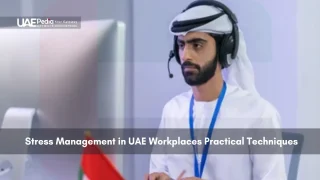 A man working in a UAE office with headphones on.