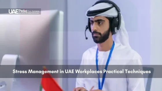 A man working in a UAE office with headphones on.