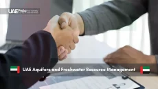 Business handshake over document discussing UAE freshwater resources