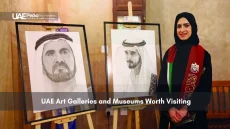 Emirati artist with portraits of UAE leaders