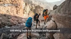 Hikers on rugged trail in UAE mountains showcasing adventure routes