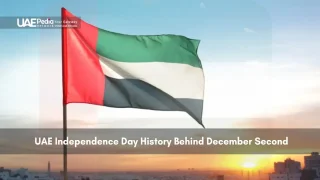 UAE national flag waving in the sky during sunset