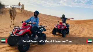 Two people riding quad bikes in the Dubai desert
