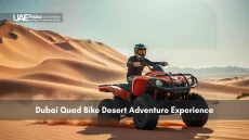 Person riding red quad bike on Dubai sand dunes