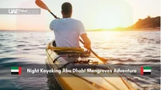Man kayaking at sunset through Abu Dhabi’s mangrove waters.