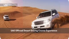 White SUV navigating desert dunes in offroad driving course