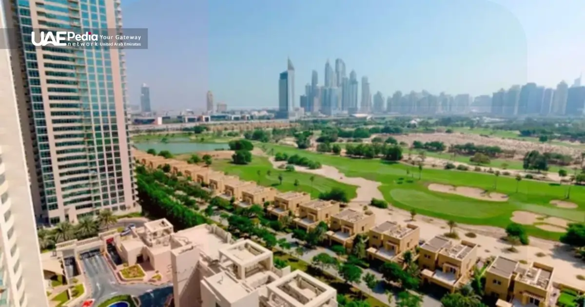 Aerial view of Dubai golf course with villas and high-rises beyond