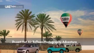 Hot air balloons over Dubai desert with palm trees and vehicles