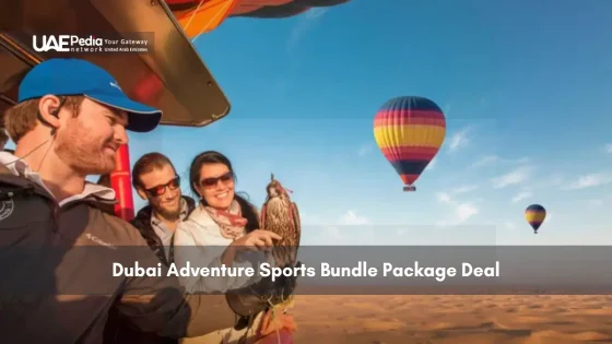 Tourists holding falcon with hot air balloons in Dubai desert