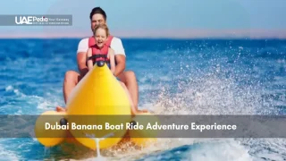 Father and child riding yellow banana boat on water in Dubai