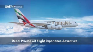 Emirates airplane flying over the clouds in the sky