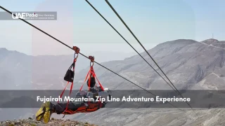 Person zip lining over rocky mountains in Fujairah