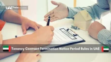 Hands over tenancy contract and house model on table