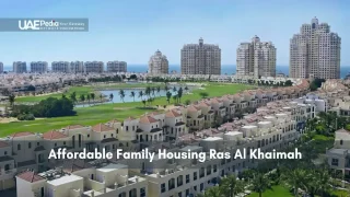 Villas and towers overlooking green space and coastline in Ras Al Khaimah.