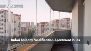 A glass-enclosed balcony in a high-rise apartment offering panoramic views of surrounding towers