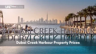 View of Dubai Creek Harbour boardwalk with hashtag signage, palm trees and skyline reflection