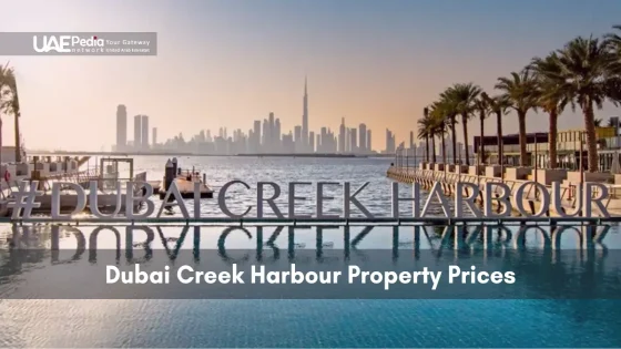 View of Dubai Creek Harbour boardwalk with hashtag signage, palm trees and skyline reflection