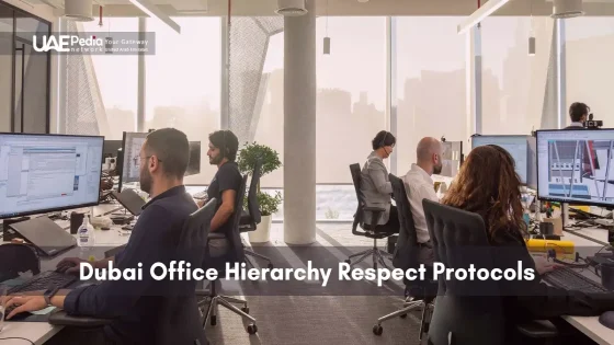 Employees at desks with monitors in a sunlit Dubai office observing hierarchy protocols.