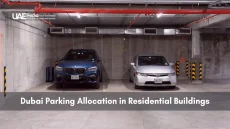Two cars parked side by side in an underground concrete garage of a Dubai residence.