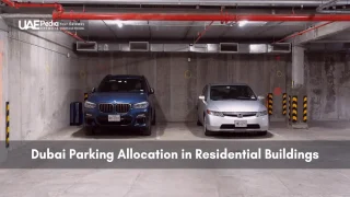 Two cars parked side by side in an underground concrete garage of a Dubai residence.