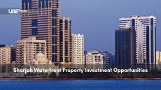 Modern skyscrapers and a mosque along Sharjah's waterfront.