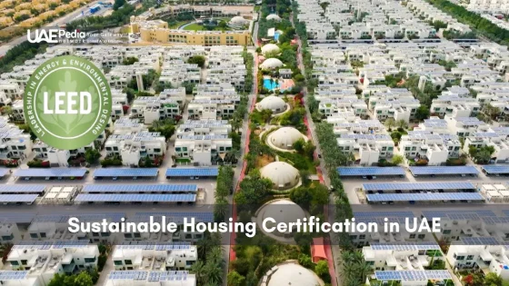 Top-down view of Emirati residential area with solar arrays and LEED emblem