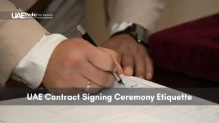 Hand signing official document during a UAE business contract ceremony.