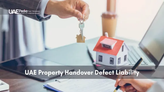 Handing a house key over documents next to a house model and laptop to illustrate liability