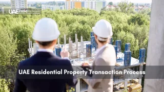 Two professionals in hard hats examining a residential construction site among trees