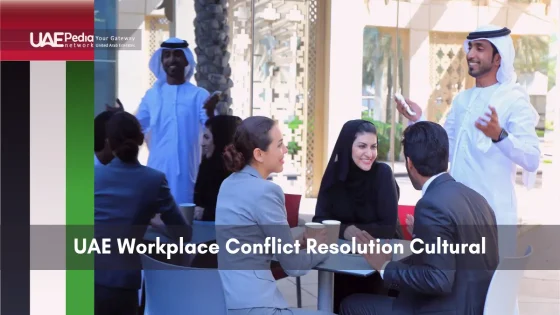 Group of Emirati and expatriate colleagues discuss work matters at an outdoor cafe table