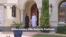 A family in front of a modern, well-secured Dubai villa highlighting safety features.