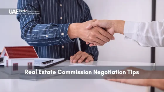 Businesspeople shaking hands over property documents and a model house.